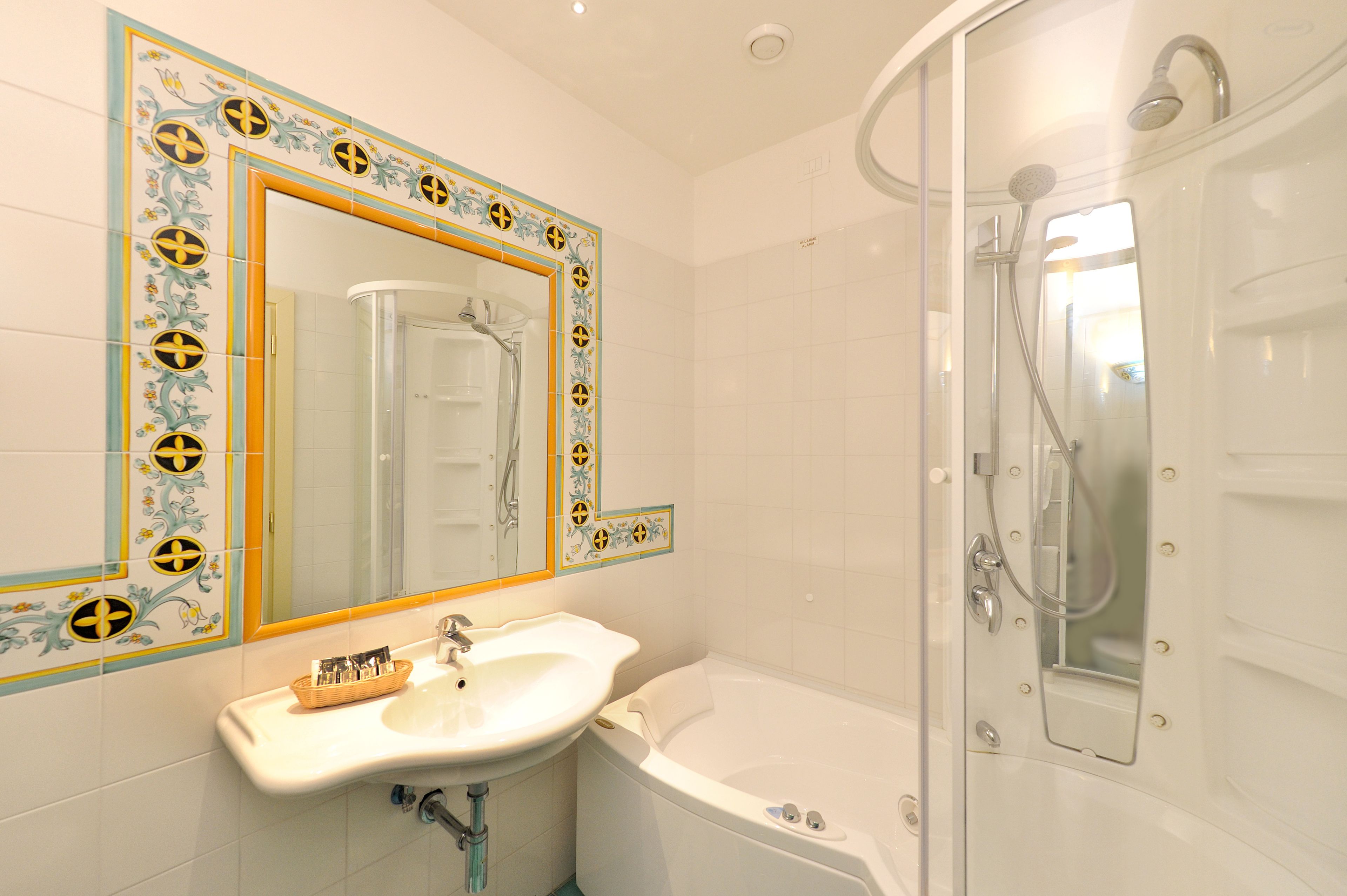 A bathroom with a white sink, a bathtub, and a shower enclosure.