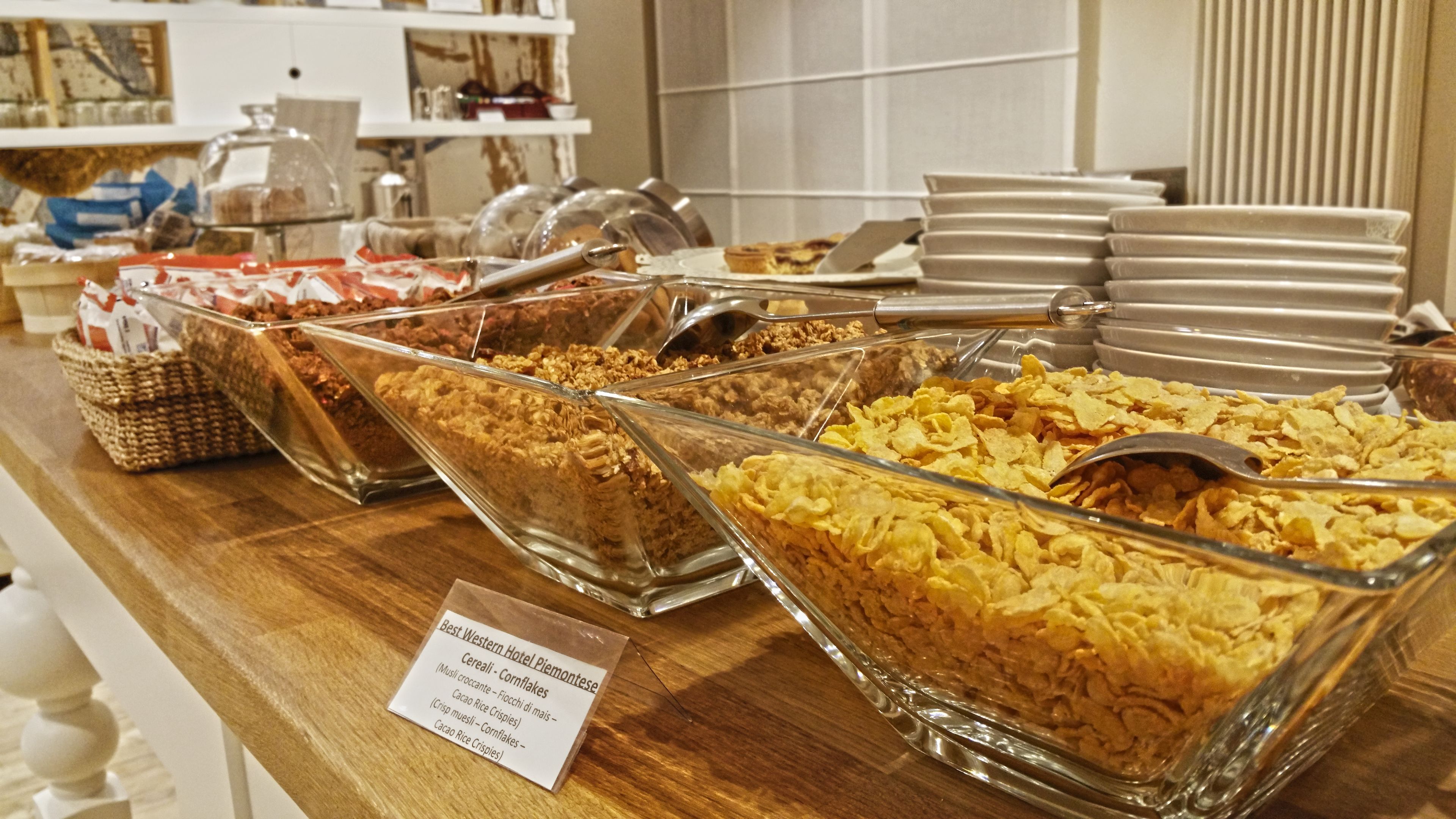 A buffet with various food options including cereal, granola, and rice crisps.