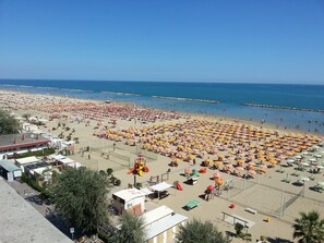 On the beach, beach cabanas, beach towels, beach volleyball