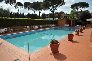 Seasonal outdoor pool, open 9:00 AM to 8:00 PM, pool umbrellas