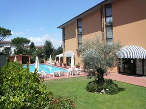Seasonal outdoor pool, open 9:00 AM to 8:00 PM, pool umbrellas