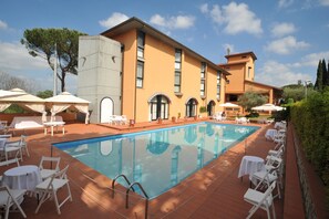 Seasonal outdoor pool, open 9:00 AM to 8:00 PM, pool umbrellas