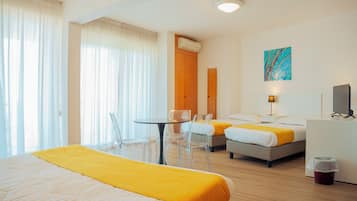 Standard Quadruple Room, Balcony, Pool View | Minibar, in-room safe, desk, soundproofing