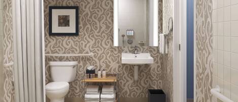 A bathroom with a toilet, sink, and shower curtain.