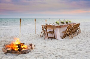 On the beach, white sand, sun loungers, beach umbrellas