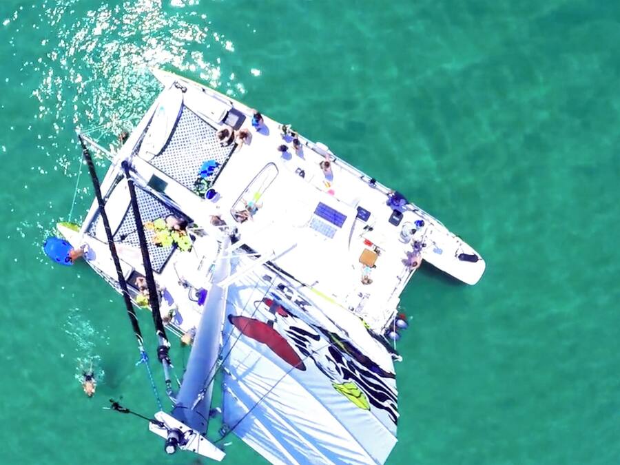 An aerial view of a floating structure with a deck, seating, and various equipment.