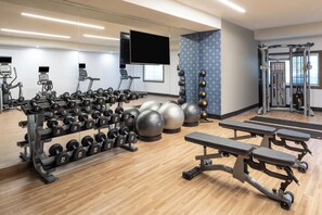 A gym with various exercise equipment, including dumbbells, medicine balls, and a treadmill. - Four Points by Sheraton Chicago Schaumburg (Schaumburg)