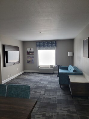 Suite, 1 King Bed, Non Smoking | Desk, laptop workspace, blackout drapes, iron/ironing board
