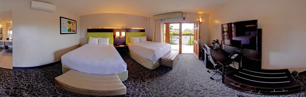 A hotel room with two beds, a TV, and a balcony.