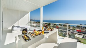 A balcony with a dining setup overlooking the sea, featuring a white interior and a clear view of the ocean. - Hotel SU & Aqualand (Antalya)