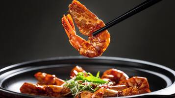 A dish with cooked shrimp and greens on a plate.