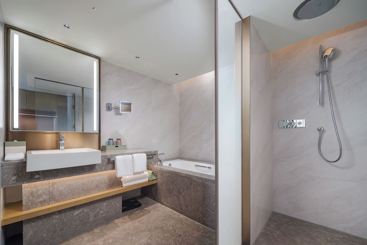 Premium Suite, 1 King Bed | Bathroom | Bathtub, deep soaking tub, rainfall showerhead, free toiletries