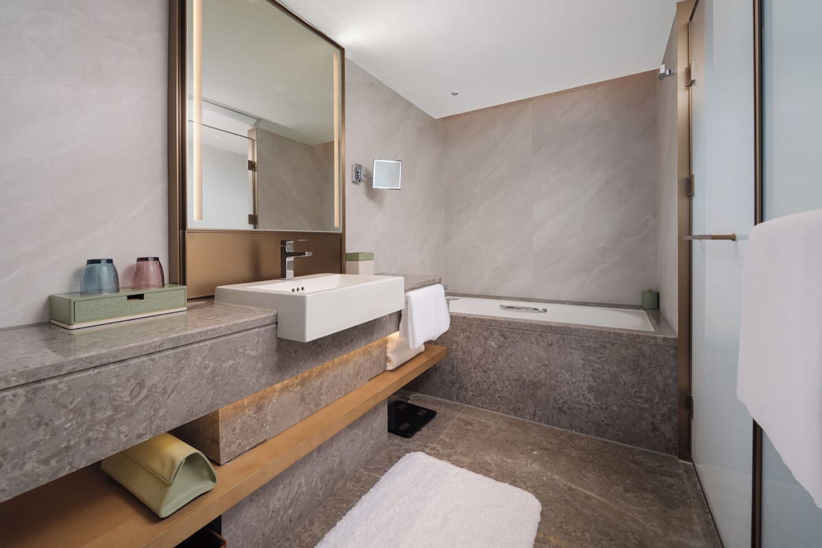 Junior Suite, 1 King Bed | Bathroom | Bathtub, deep soaking tub, rainfall showerhead, free toiletries