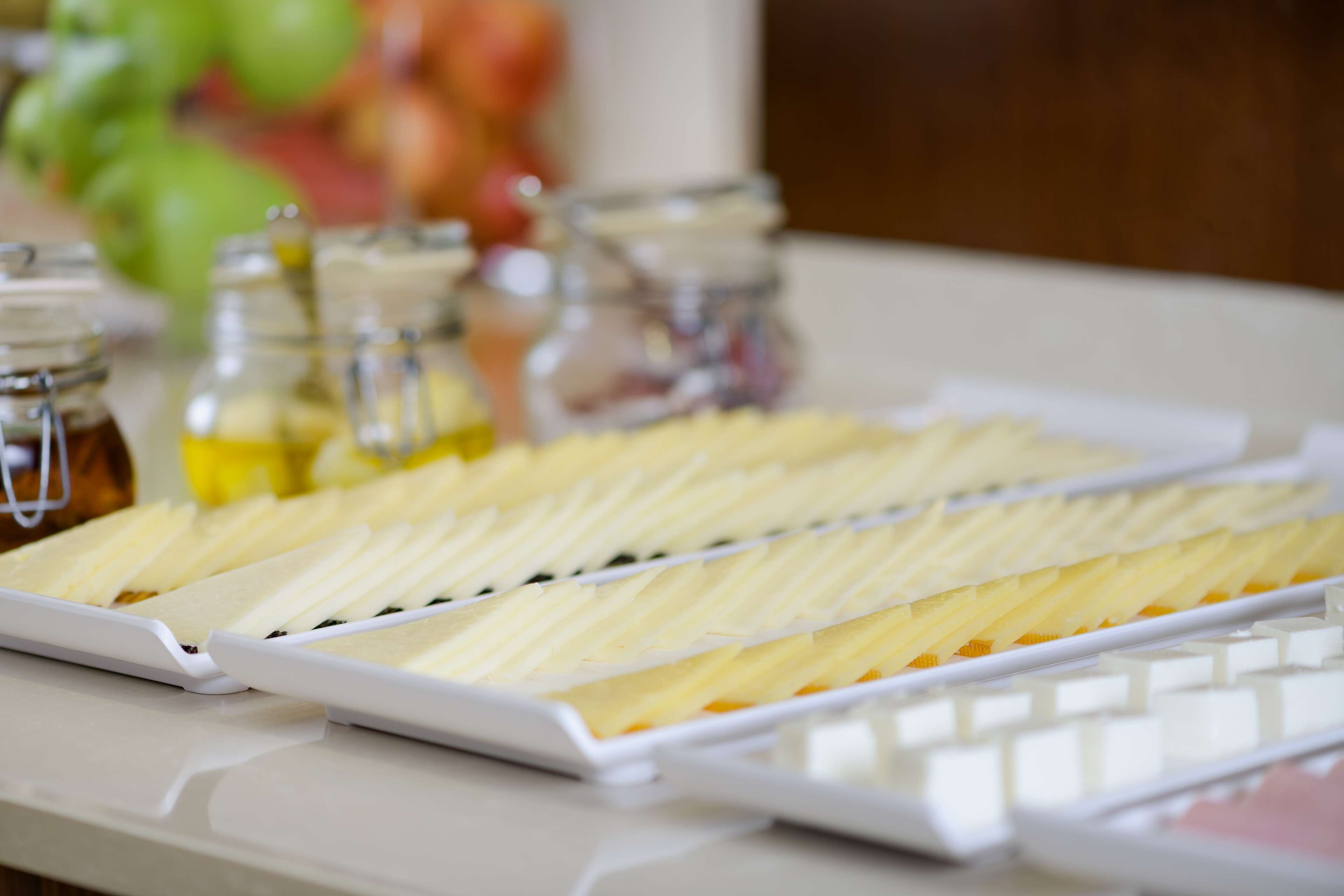 A tray of sliced fruits and a white tray with a grid pattern.