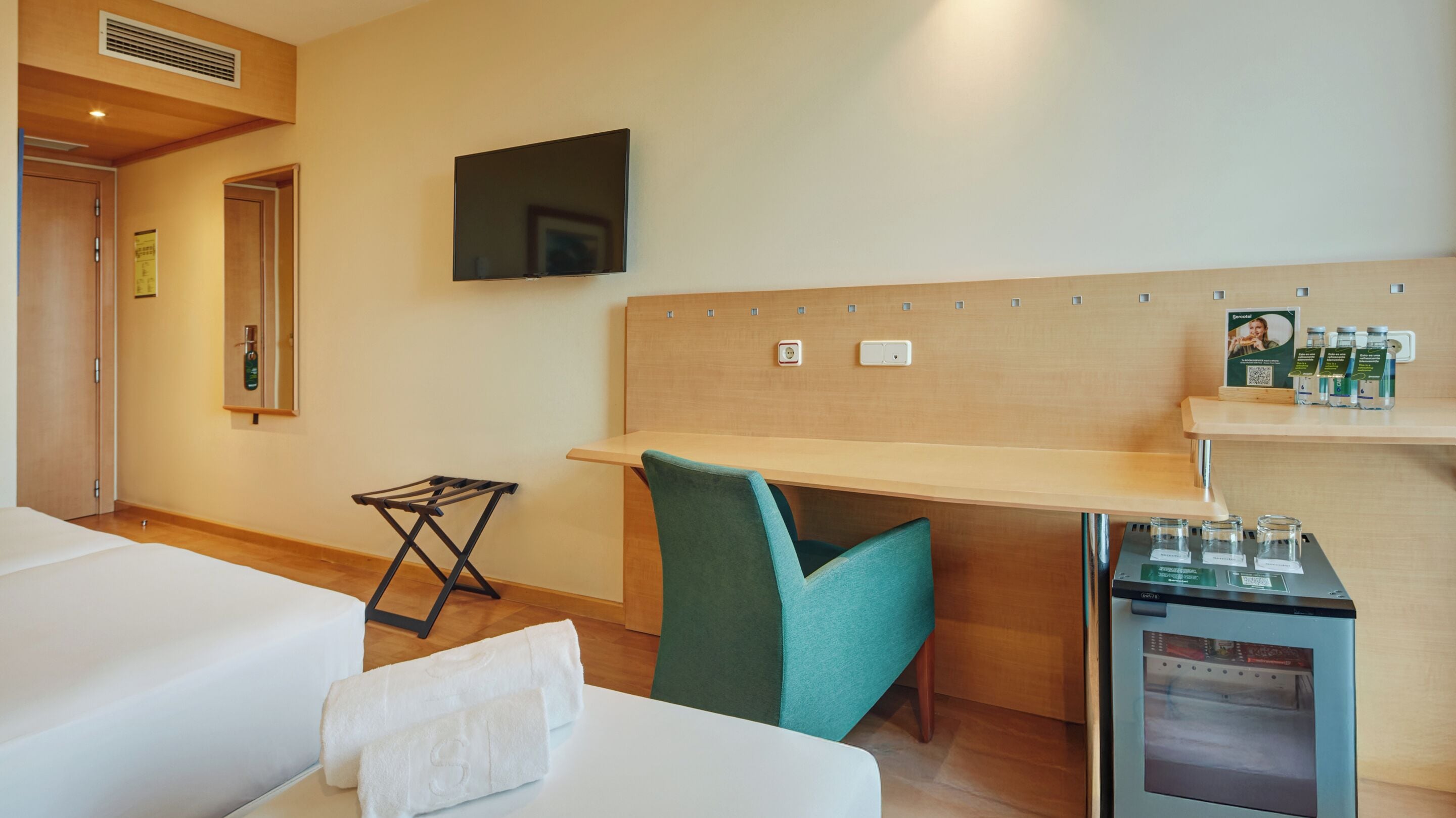 family room | minibar, in-room safe, desk, blackout curtains