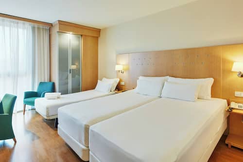 Family Room | Minibar, in-room safe, desk, blackout drapes