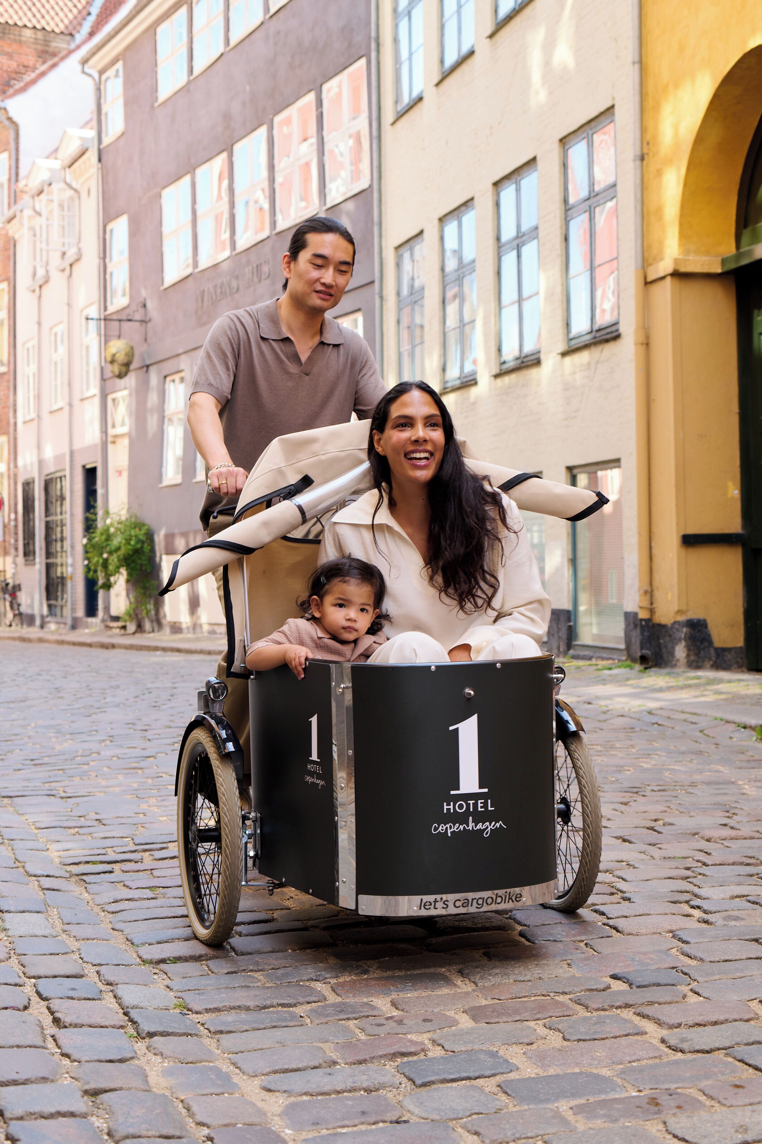 A cargo bike with a black box labeled 'HOTEL Copenhagen' and the number '1'.