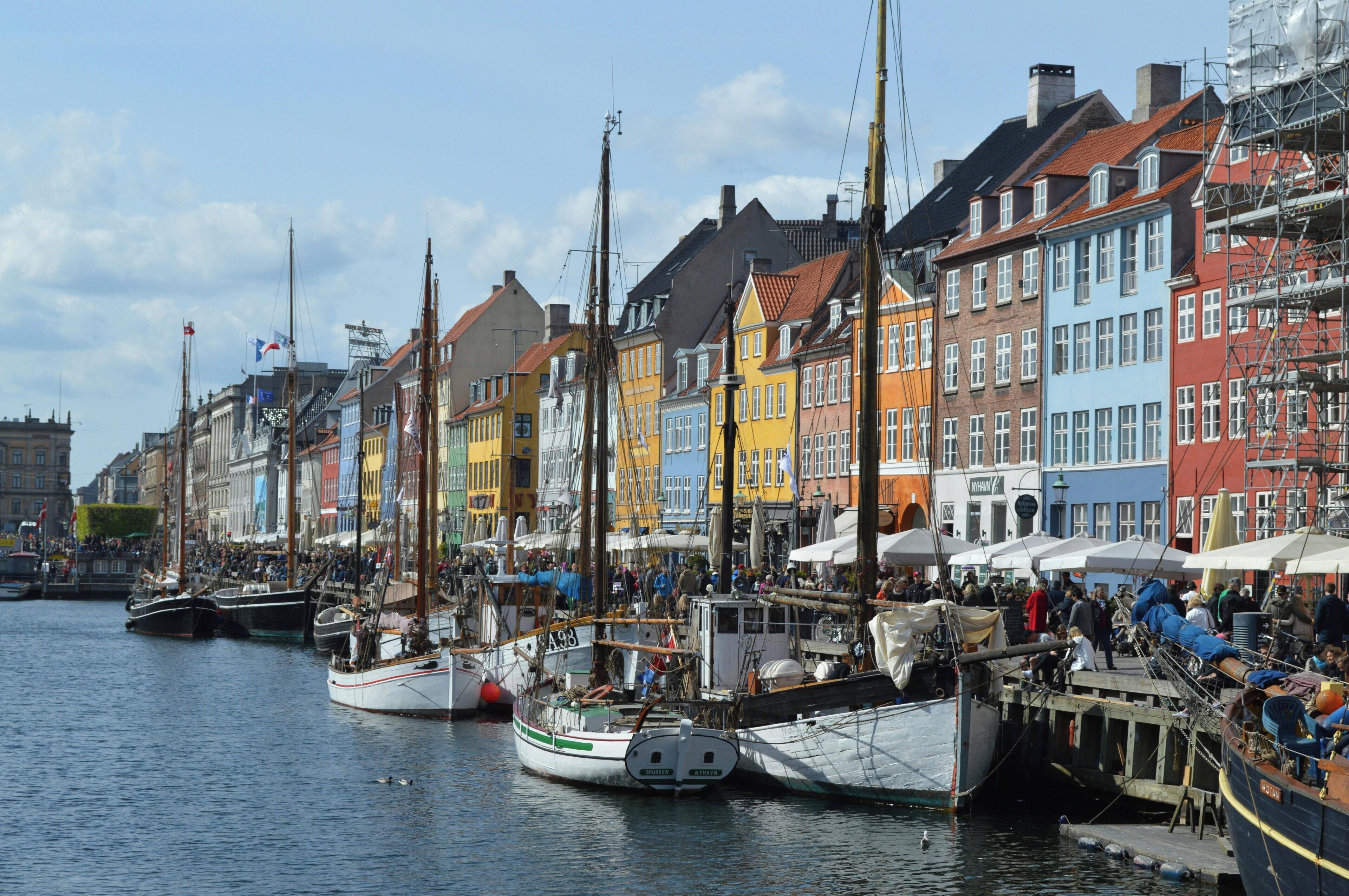 A harbor with colorful buildings and boats docked along the waterfront.