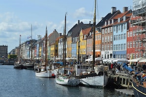 A harbor with colorful buildings and boats docked along the waterfront.