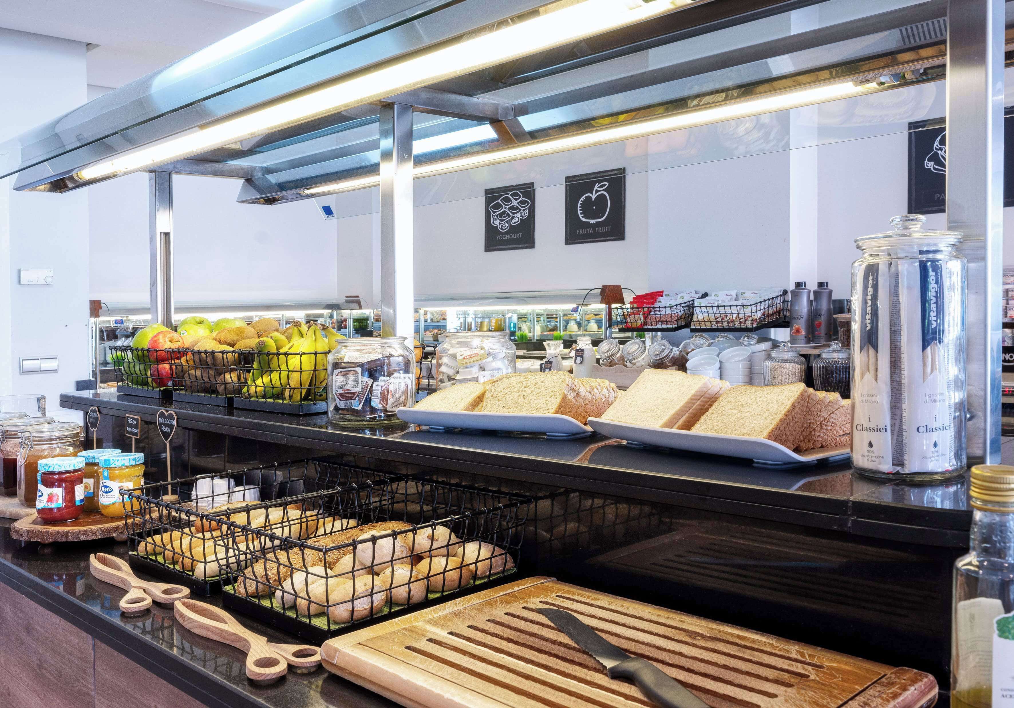 A bakery display with bread, pastries, and fruits.