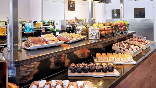 A buffet with various food items and beverages.