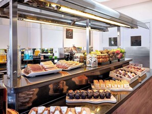 A buffet with various food items and beverages.