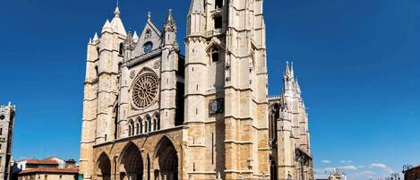 A large cathedral with a prominent clock tower and intricate architectural details.