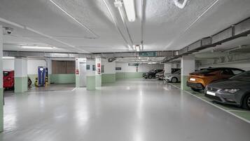 A parking garage with multiple levels, clear signage for hotel access, and a clean, well-lit environment.