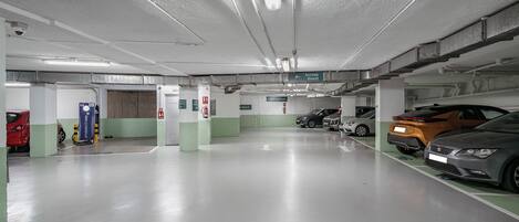 A parking garage with multiple levels, clear signage for hotel access, and a clean, well-lit environment.