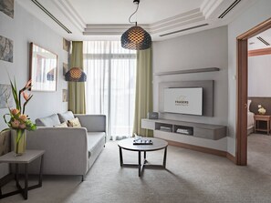 Appartement Deluxe, 1 très grand lit | Coin séjour