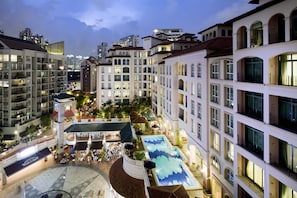 A hotel courtyard with a swimming pool, outdoor seating, and a clock tower. - Fraser Place Robertson Walk, Singapore (Singapore)