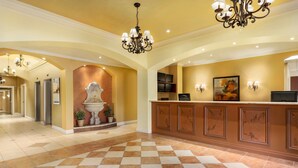 A hotel lobby with a checkered floor, a reception desk, and a chandelier. - Days Inn & Suites by Wyndham Niagara Falls Centre St. By the Falls (Niagara Falls)