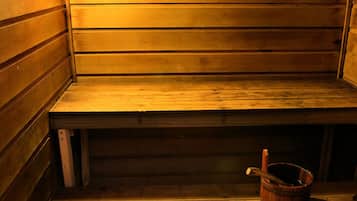 A sauna with wooden benches and a tiled floor.