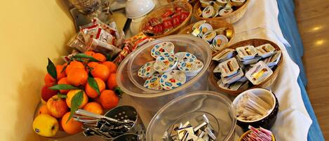 A buffet table with various food items and condiments.