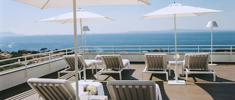 Seasonal outdoor pool, open 10:00 AM to 7:00 PM, pool umbrellas