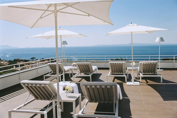 Seasonal outdoor pool, open 10:00 AM to 7:00 PM, pool umbrellas