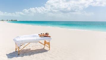 Relax on the beach with a soothing massage overlooking the ocean.