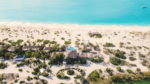 An aerial view of a resort with multiple buildings, a swimming pool, and a beach. - Pine Cay, Turks and Caicos (Pine Cay)