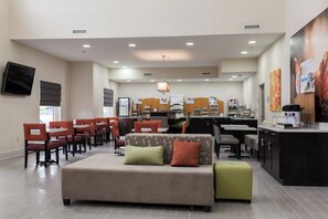 A hotel lobby with a seating area, a reception desk, and a kitchenette. - Holiday Inn Express & Suites Sweetwater by IHG (Sweetwater)