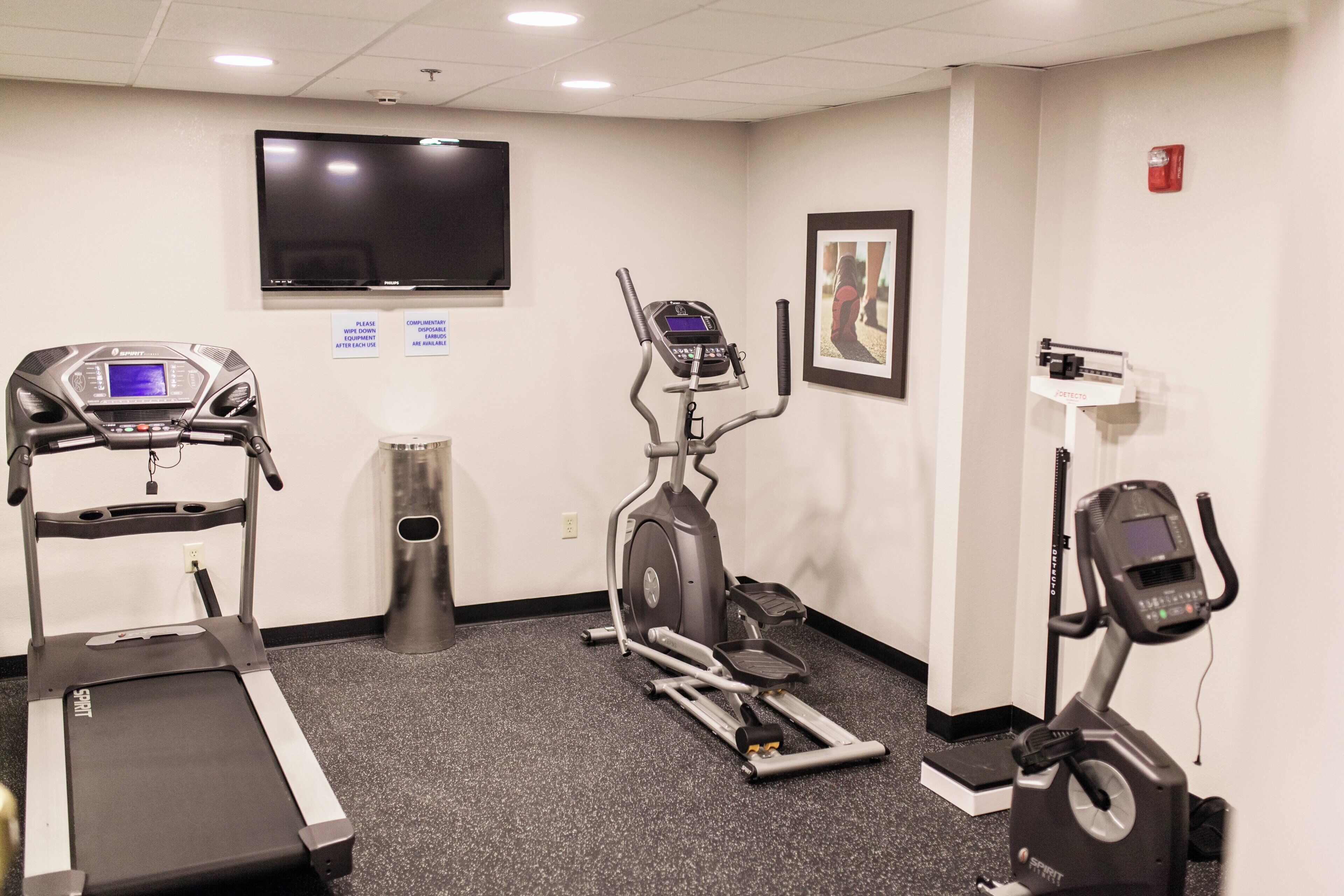 A fitness center with treadmills, an elliptical, and a stationary bike.