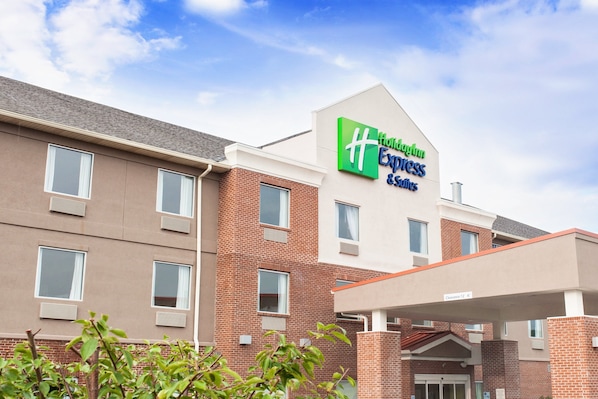 A Holiday Inn Express building with a brick facade, multiple windows, and a clear sky.