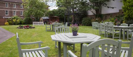 A garden patio area with outdoor seating and a gazebo.