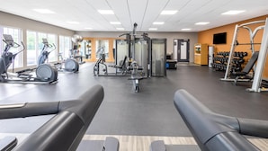 A gym with treadmills, weight machines, and free weights.