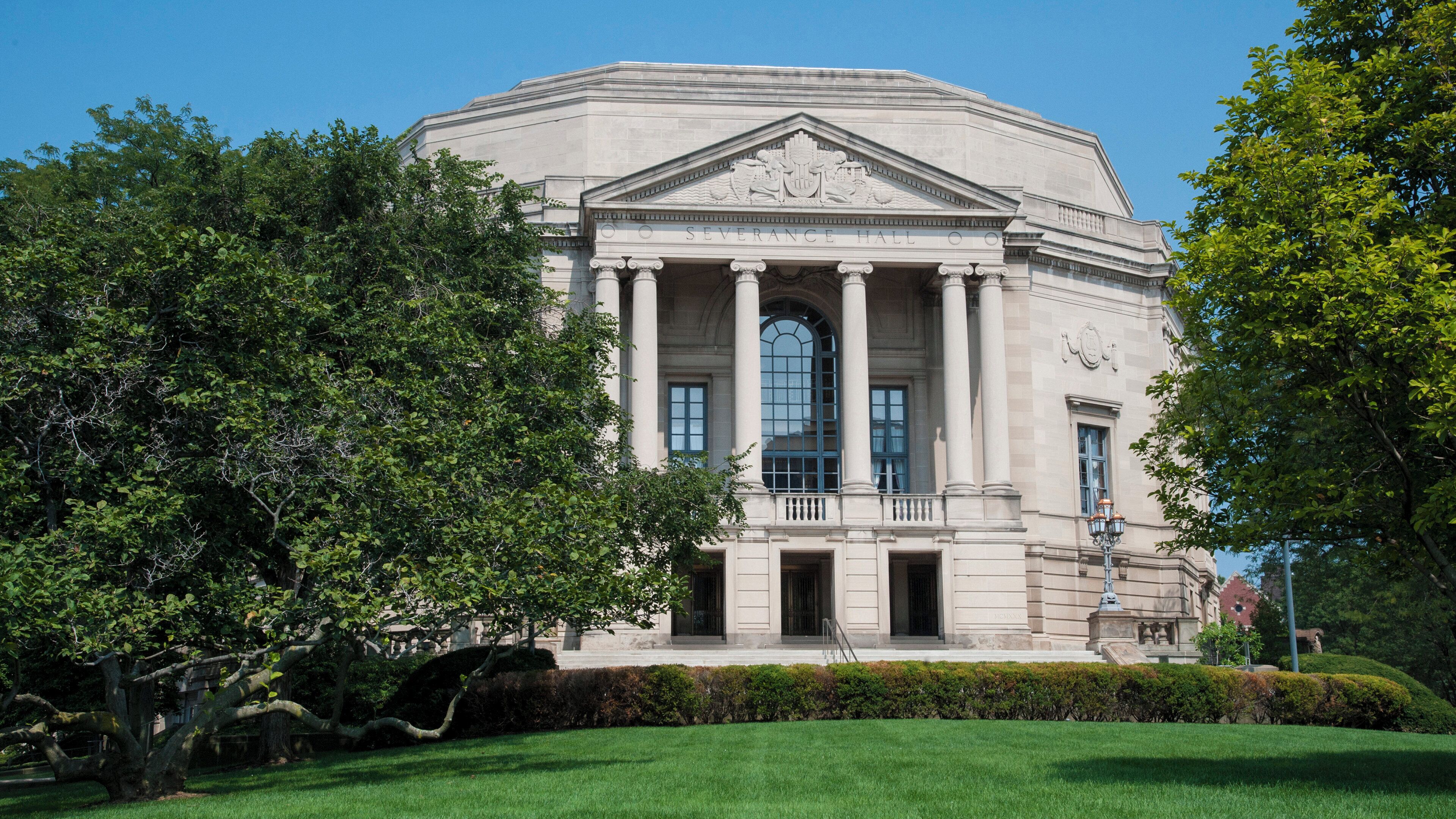 A large neoclassical building with a central dome, columns, and a grand entrance.