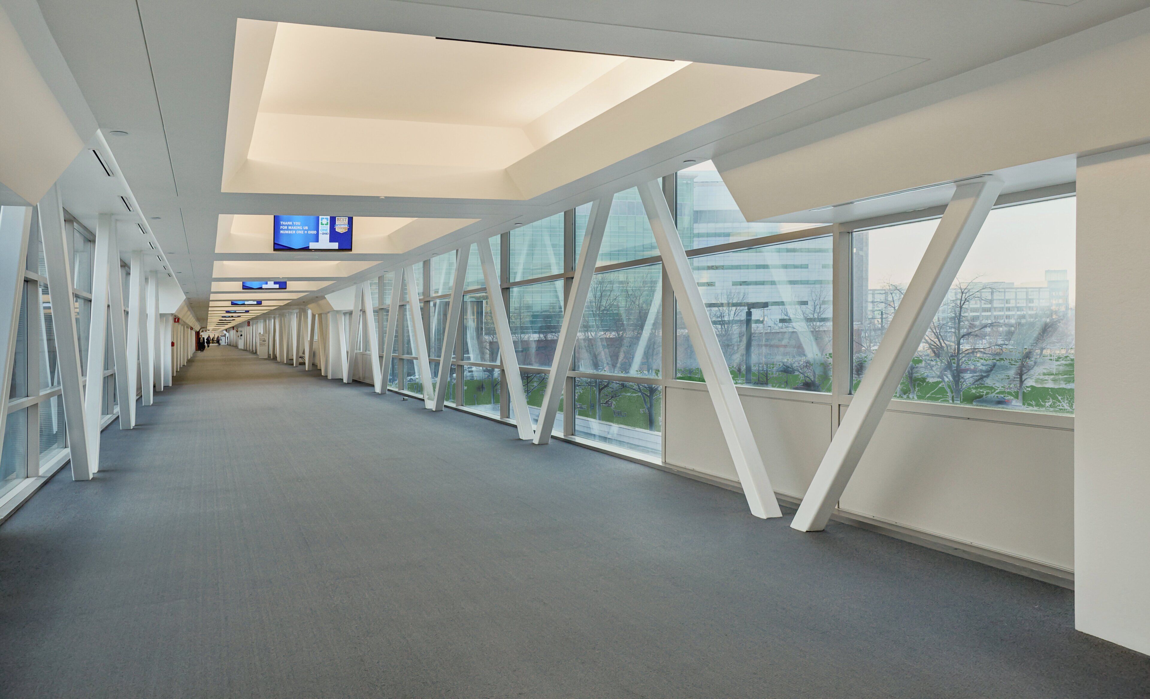 A corridor with large windows and a flat ceiling.