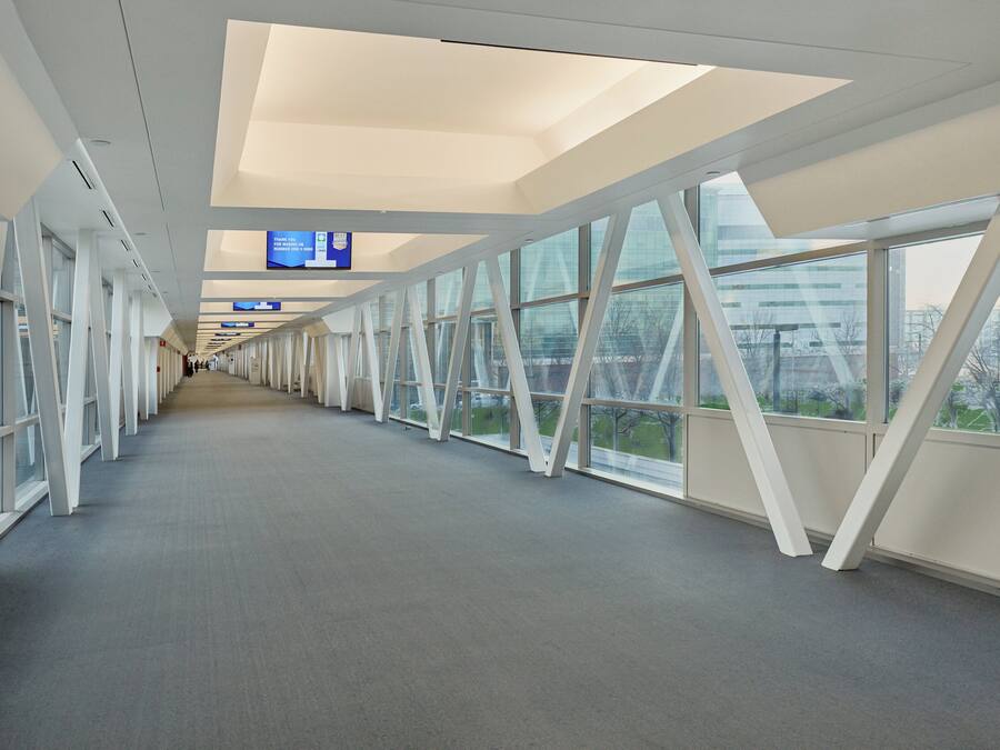A corridor with large windows and a flat ceiling.