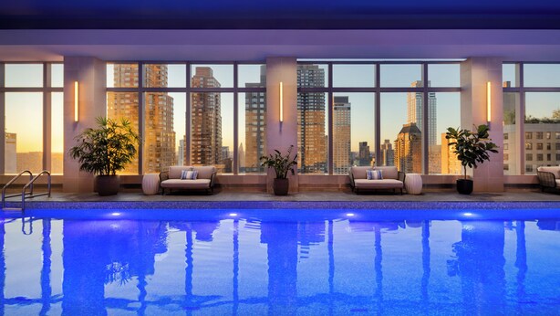 A swimming pool with city views, potted plants, and seating areas. - Mandarin Oriental, New York (New York)
