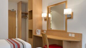 A hotel room with two beds, a wooden desk, a chair, a mirror, and a coat rack. - Ramada by Wyndham Wakefield (Ossett)