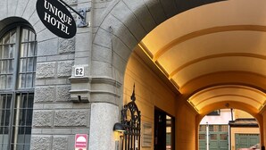 A hotel entrance with a sign reading "UNIQUE HOTEL" and the number "62". - Unique Hotel (Stockholm)