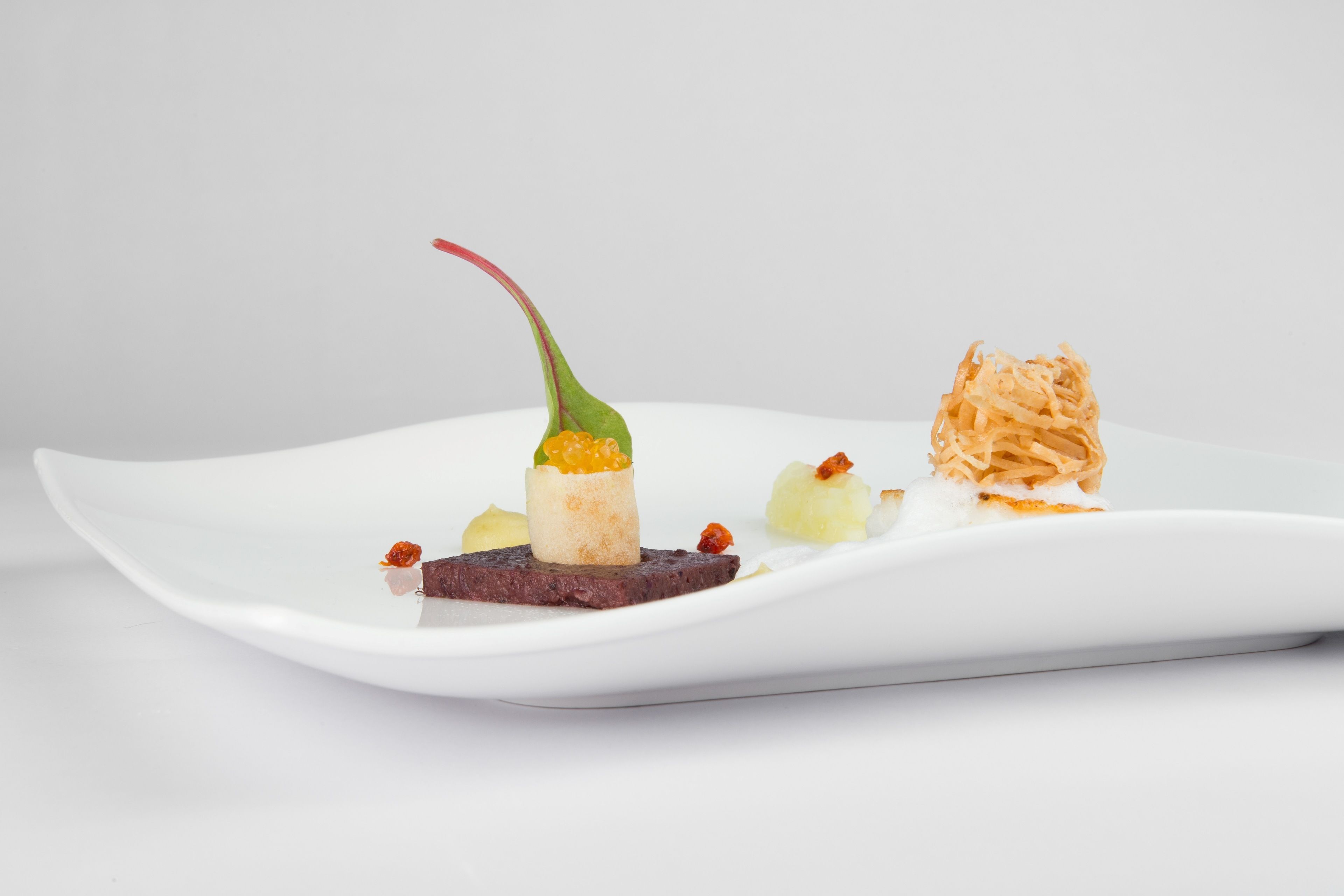 A white plate with various food items.